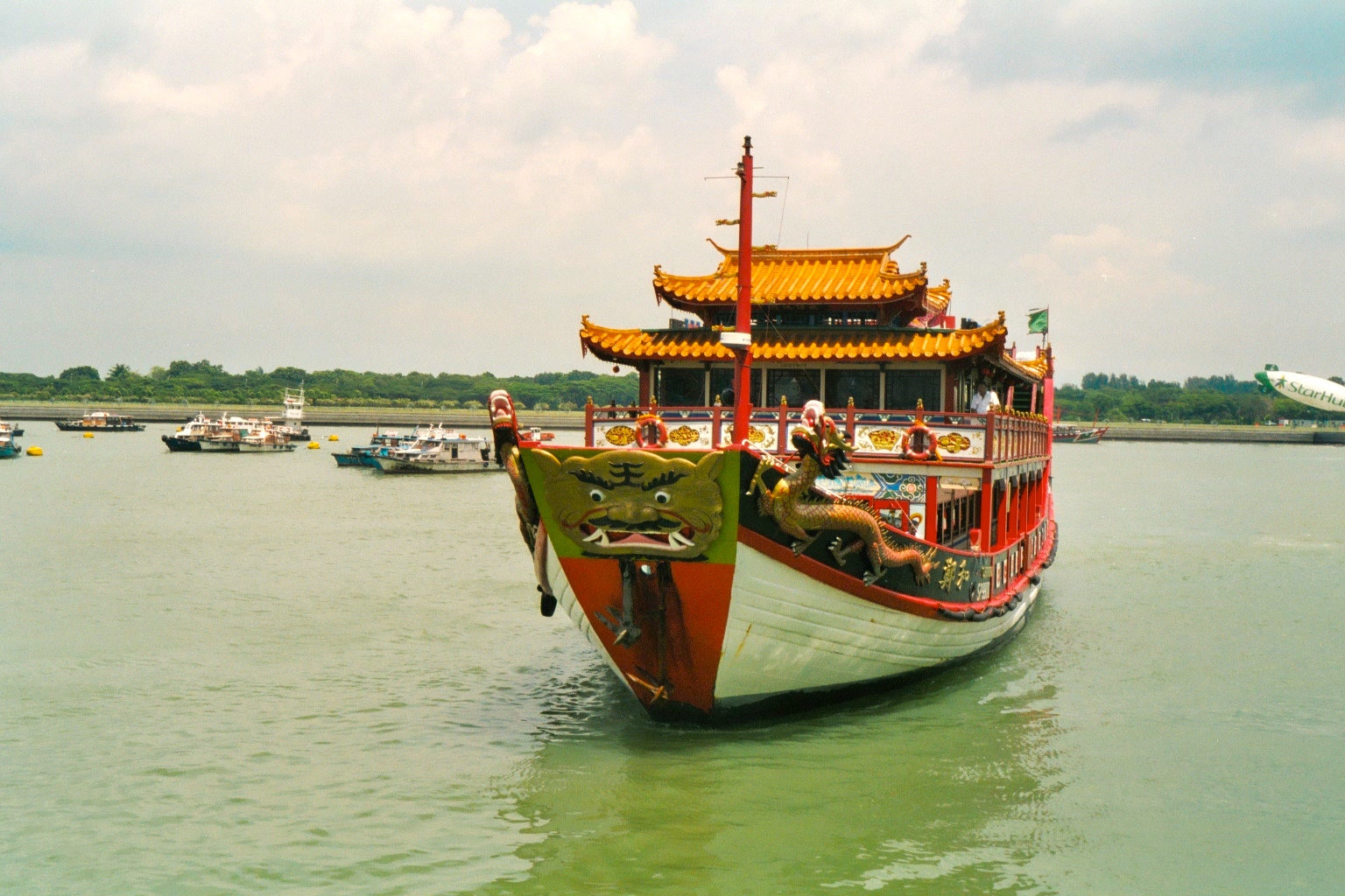 Colourful, dragon-laden Bumboat in the Singapore River.